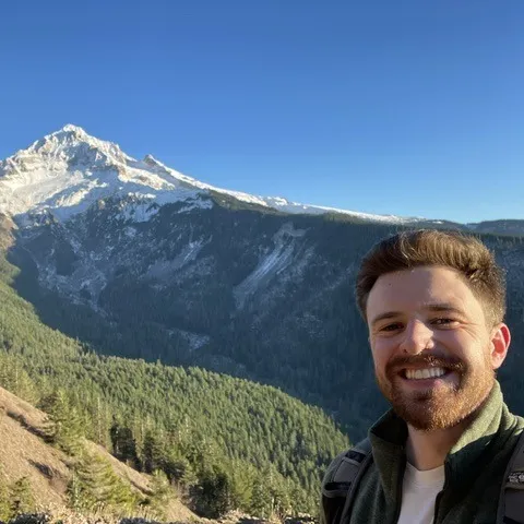 Torin, founder of LUNA Local Marketing, on a ridge below Mount Hood